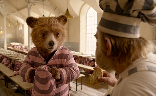 (L-R) Paddington voiced by BEN WHISHAW and BRENDAN GLEESON as Knuckles McGinty in the family adventure PADDINGTON 2 from Warner Bros. Pictures and STUDIOCANAL, in association with Anton Capital Entertainment S.C.A., a Warner Bros. Pictures release. Photo Courtesy of Warner Bros. Pictures.